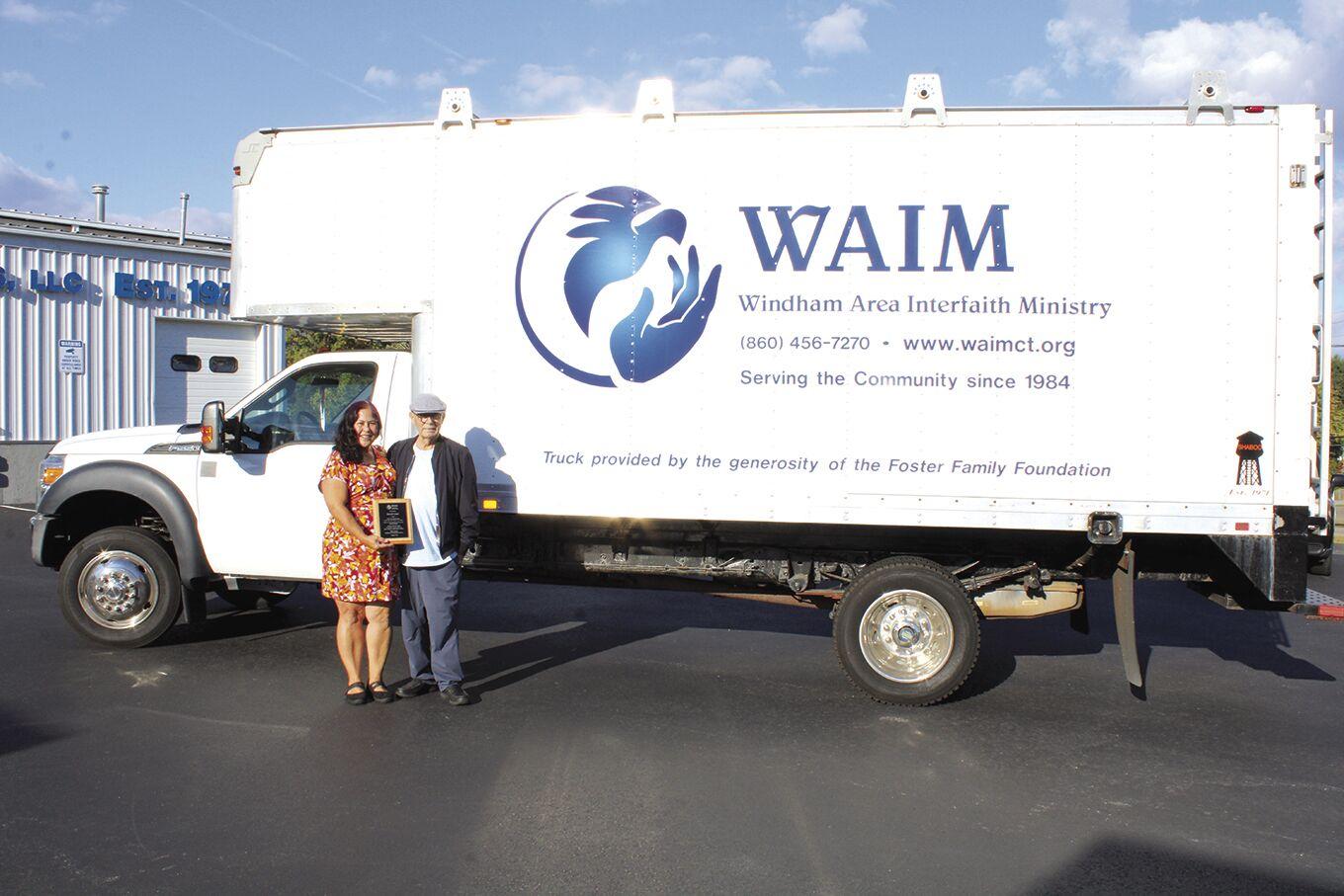 WAIM Executive Director Susan Hunter presents David Foster a plaque to thank him for donating a new truck.